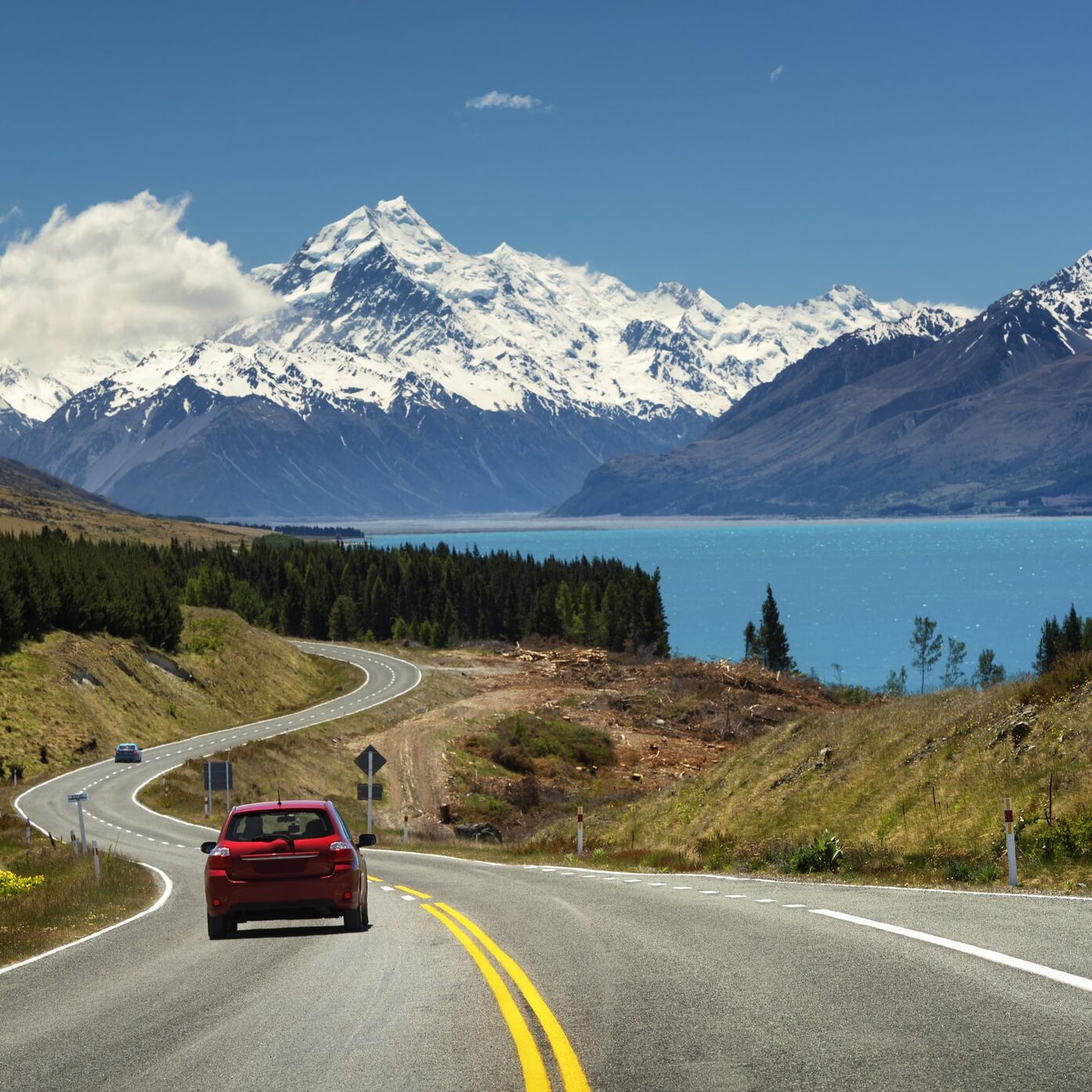 Red car going to the beautiful landscape lake tekapo, Mt.cook, Lupines fields, South island New Zealand